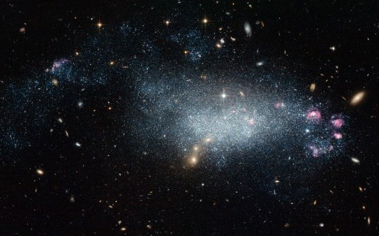 This image from the NASA/ESA Hubble Space Telescope shows a cosmic oddity, dwarf galaxy DDO 68. This ragged collection of stars and gas clouds looks at first glance like a recently-formed galaxy in our own cosmic neighbourhood. But, is it really as young as it looks?